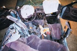 A view from the rear of the Mitsubishi Galant involved in the Dayton, OH incident, looking forward, shows crush damage on the driver&apos;s side. The victim being worked on had his feet crushed in the reat footwell area behind the driver&apos;s seat. The airbag diagnostic unit is on the driveshaft hump to the left of the passenger&apos;s seat.