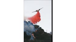 Fixed-wing aircraft joined in the attack on the fire. Here, a California Department of Forestry &amp; Fire Protection (CDF) S-2 drops retardant on the fire line near the end of daylight on the first day of the incident.