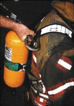 The shoulder straps of this SCBA harness contain a wire wrapped by the material. Depending on how the firefighter is positioned, it may be necessary to loosen these straps so that you can hook them both. The shoulder straps of this SCBA harness contain a wire wrapped by the material. Depending on how the firefighter is positioned, it may be necessary to loosen these straps so that you can hook them both.