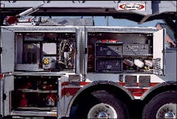 The Burtonsville, MD, Fire Department designed its short-wheelbase rear-mount ladder to carry tools and equipment in a logical manner, including this array of tool boxes, portable lights and power saws.