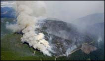 The Moose Fire continues to burn west of Glacier National Park and north of Columbia Falls, Mont., Saturday, Sept. 1, 2001. The wind-driven wildfire exploded overnight and more than doubled in size. The fire expanded on all sides, wiping out containment lines that firefighters had established in the previous week as it grew from 19,000 acres on Friday to 40,300 acres by Saturday morning, an official said.
