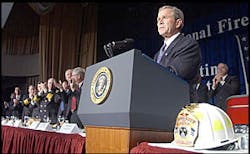 Pres. Bush is given a standing ovation during his remarks at the Nat&apos;l Fire &amp; Emer. Services dinner in Washington, April 18, 2002.