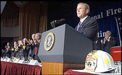 Pres. Bush is given a standing ovation during his remarks at the Nat'l Fire & Emer. Services dinner in Washington, April 18, 2002. Pres. Bush is given a standing ovation during his remarks at the Nat'l Fire & Emer. Services dinner in Washington, April 18, 2002.