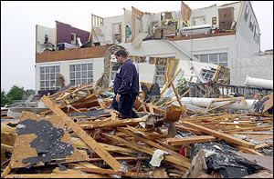 An emergency worker picks his way throught the rubble of the Davis-Bar-B-Que restaurant outside of Tate, Ga., Monday, Nov. 11, 2002. Several homes were destroyed also by overnight storms in the area.