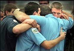 Firefighters and other emergency services personnel share their grief Sunday before a procession for three Coos Bay firefighters. Firefighters and other emergency services personnel share their grief Sunday before a procession for three Coos Bay firefighters.