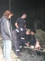 Members of the South Robeson Rescue Squad find the remains of a stuffed doll in the rubble.