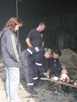 Members of the South Robeson Rescue Squad find the remains of a stuffed doll in the rubble. Members of the South Robeson Rescue Squad find the remains of a stuffed doll in the rubble.