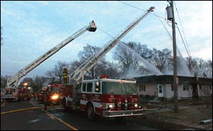 Firefighters continue to battle the blaze at 1412 S. 14th St., No. 2, at 7:30 a.m. today. An explosion brought Pekin police, firefighters ad Advanced Medical Transport personnel to the scene early this morning.