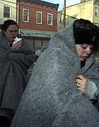 Sandra Sharma leaves the burning thrift shop. Cops have charged her with arson and murder.