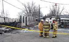 Firefighters discussed plans for storing equipment that was salvaged Saturday from the Wysox Fire Hall. The firefighters are standing in front of the remains of the hall, which was destroyed by fire Saturday morning