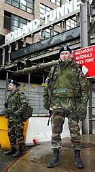 KEEPING GUARD UP: National Guardsmen Joseph Brusehaber and Jeremy Hitt man a checkpoint outside the Holland Tunnel yesterday.