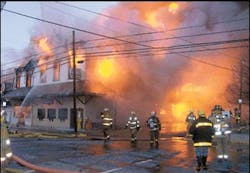 Firefighters battle flames Sunday at the Knotty Pine Restaurant just before the building's facade toppled onto Elm Street, Tionesta. At least three firefighters were injured throughout the evening. Firefighters battle flames Sunday at the Knotty Pine Restaurant just before the building's facade toppled onto Elm Street, Tionesta. At least three firefighters were injured throughout the evening.