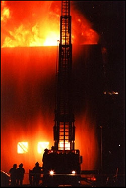 Worcester firefighters operate a ladder pipe