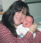 SPECIAL DELIVERY: Kathleen Gormley holds baby Kevin, who was born after his daddy got called up to the USS Constellation in the Gulf.
