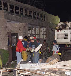 Rescue workers remove blocks of rubble at the National Guard Armory in Pierce City, Mo. in the early morning hours of Monday May 5, 2003. Victims were reportedly buried after a tornado passed through the area on Sunday evening. Eight people were feared dead in the city's damaged National Guard Armory, Lawrence County Sheriff Doug Seneker said