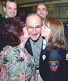 Heart-attack survivor Joseph Calvanese gets a kiss from wife Mary and Emergency Medical Technician Amander Schmidt yesterday at a 'Second Chance Brunch' honoring EMTs.