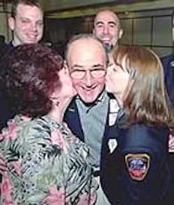 Heart-attack survivor Joseph Calvanese gets a kiss from wife Mary and Emergency Medical Technician Amander Schmidt yesterday at a 'Second Chance Brunch' honoring EMTs.