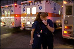 Nurse Angela Morgan (left) comforts paramedic Candace Hardwick outside The Med Sunday night after firefighter Charles Zachary was brought in. He later died.