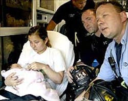 Gloria Reyes and daughter Emily are safe and sound after Fire Capt. Tom Riley (right) and firefighter Michael McCrory (center) scaled a ladder to rescue them yesterday from a fire in their fourth-floor apartment in East Elmhurst. Gloria Reyes and daughter Emily are safe and sound after Fire Capt. Tom Riley (right) and firefighter Michael McCrory (center) scaled a ladder to rescue them yesterday from a fire in their fourth-floor apartment in East Elmhurst.