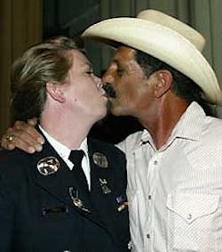 FLAMING PASSION: New Fire Battalion Chief Rocky Jones kisses hubby Jon Thomas yesterday. FLAMING PASSION: New Fire Battalion Chief Rocky Jones kisses hubby Jon Thomas yesterday.