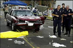 Police investigate the scene near where a body of a victim lies in front of a car that plowed through a crowded farmers market in Santa Monica, Calif., Wednesday, July 16, 2003. According to officials, at least eight people were killed and dozens injured when the vehicle sped through the popular pedestrian promenade