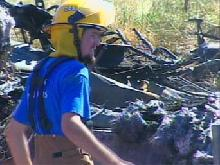 A crash scene investigators surveys the mangled metal left behind on Highway 20.