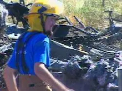 A crash scene investigators surveys the mangled metal left behind on Highway 20. A crash scene investigators surveys the mangled metal left behind on Highway 20.