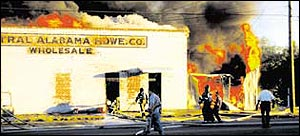 Firefighters fight to contain the fire in the 1500 block of Water Ave. According to firefighters, chemicals in the building caused an explosion, sending a fireball into the air, above.