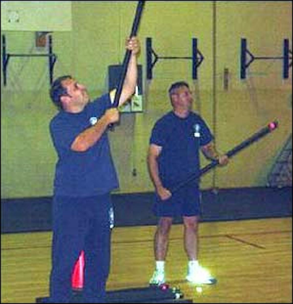 Master Fire Fighters Dave Anderson and Mike Barber raise and lower weighted rods for 90-seconds simulating hooking a ceiling.