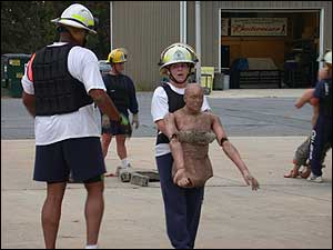 LT Charles Bailey asks LT Stacey Daniel where her dummy's legs went during this PT station. She said,