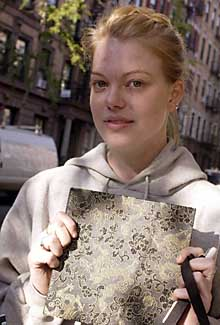 Brett Helsham, a student, holds her journal, which she salvaged after a fire burned through her apartment.