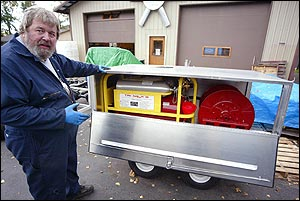 Vick Fahlsing builds the trailers and assembles portable firefighting units at his shop in Eagle River, Alaska. In rural Alaska, dozens of villages now have the equipment, that is called 'fire department in a box,' a new concept in firefighting. The equipment, contained in two shiny metal trailers that can be hooked up to small pickups, all-terrain vehicles or even snowmobiles, uses compressed air to produce firefighting foam from a small amount of water.