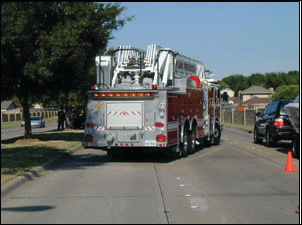 With the tandem-axle ladder truck blocking for the ambulance, a protected work area of almost three lanes of traffic is created. With this 'block to the left', the driver/operator exits into traffic, but the officer and crew exit to the shadow side.