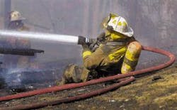 A firefighter hoses down a blaze in Spotsylvania. The county's fire service faces some of the problems noted in a statewide survey A firefighter hoses down a blaze in Spotsylvania. The county's fire service faces some of the problems noted in a statewide survey