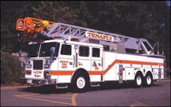 Rear-mount aerial ladder units offer large body compartments without sacrificing fire pump, water tank and hosebed areas that are used on quint apparatus. Note the short ladder overhang in front of the cab on this Seagrave rear-mount ladder company apparatus operated by the Tenafly, NJ, Fire Department. Rear-mount aerial ladder units offer large body compartments without sacrificing fire pump, water tank and hosebed areas that are used on quint apparatus. Note the short ladder overhang in front of the cab on this Seagrave rear-mount ladder company apparatus operated by the Tenafly, NJ, Fire Department.