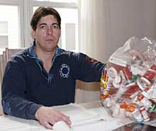 PAINFUL BATTLE: Former firefighter Michael Romanelli, with a bag of medications he has taken for his injured back, has been trying to get a full disability pension since 1989.