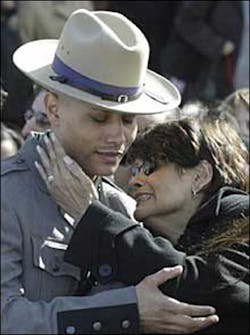 State Trooper Kevin Gonzalez hugs his crying mother, Gloria, (above) yesterday after the funeral of his brother Erick. State Trooper Kevin Gonzalez hugs his crying mother, Gloria, (above) yesterday after the funeral of his brother Erick.