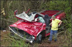 A pickup rests in a shallow ravine beside U.S. 72 on Friday in the Locust Shores community.