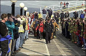 The procession of brothers carrying Mark's body up the ramp from the MV Mt. Washington dock at Weirs Beach.