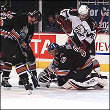 Olie Kolzig saves a shot on goal during Wednesday's game against the Buffalo Sabres at the MCI Center. The Washington Capitals hosted public safety personnel from the National Capital Area for Hero's night, which included a video tribute to 'Dino'. Washington Sports and Entertainment provided a suite for the Mahaffey family during the game.