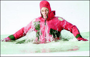 Laconia Firefighter Mark Miller breaks the surface of the water during cold-water rescue training in Lake Opechee in December 2002. Miller, who died during a dive training exercise last Thursday, was known for his work to establish a dive team.