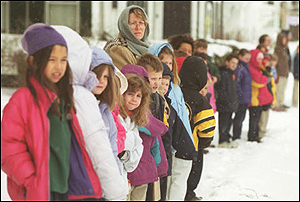 Children from the city&rsquo;s elementary schools line the route of the funeral cortege for Laconia Firefighter Mark Miller as it makes its way slowly to Our Lady of the Lakes Church Wednesday.