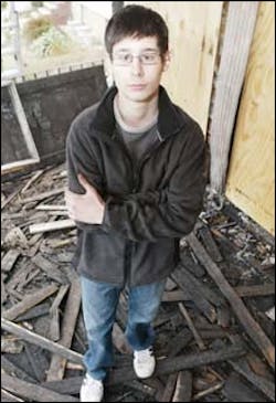Charles Sotiriou, 14, yesterday stands amid the charred remains of the porch where the Staten Island fire broke out. Charles Sotiriou, 14, yesterday stands amid the charred remains of the porch where the Staten Island fire broke out.