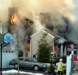 Firefighters rush to battle a house fire on Crestwood Circle in Budd Lake Tuesday. The fire injured the couple who lived in the home. The couple and firefighters were apparently unable to rescue their dog, Coco. Firefighters rush to battle a house fire on Crestwood Circle in Budd Lake Tuesday. The fire injured the couple who lived in the home. The couple and firefighters were apparently unable to rescue their dog, Coco.