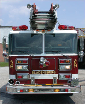 This Seagrave rear-mount ladder from Bladensburg, MD, has no obstructions at the tip of the aerial, which makes roof work much easier. Note the hand tools mounted on the front bumper.