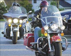 Jim Collins, founder of the Maryland chapter of the Red Knights, leads a group of fellow riders out of the Jim Collins, founder of the Maryland chapter of the Red Knights, leads a group of fellow riders out of the