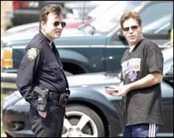 FREE PASS: A baseball fan flashes ID at a cop to score a free parking spot outside Shea