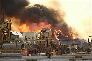 Flames and heavy toxic smoke fueled by cardboard and tire scraps, pour out of the property of Island Recycling Co. in Honolulu.