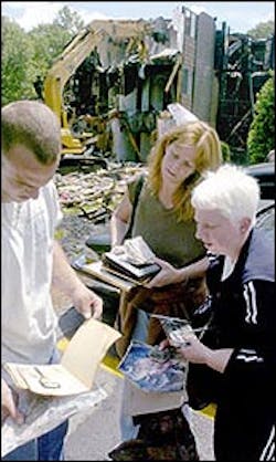 Residents David Faticanti, left,and Sue Faticanti, center, help neighbor Mary Fitzgerald, right, look through photos salvaged from the debris. Residents David Faticanti, left,and Sue Faticanti, center, help neighbor Mary Fitzgerald, right, look through photos salvaged from the debris.