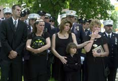 At the memorial service for Firefighter Chris Trumpf, held at the Presbyterian Church in Morristown Tuesday, from left, son Bill, daughter Tracy, daughter April Tribus and granddaughter Chelsea Tribus, and wife Debbie watch as Trumpf's casket is driven away after the service.